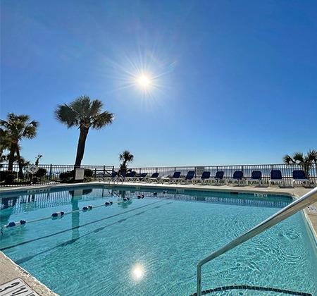 The sun shining down on the outdoor pool at the Polynesian Oceanfront hotel in Myrtle Beach